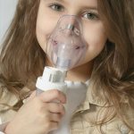 Girl with nebulizer mask
