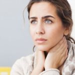 The girl put her hands to her throat