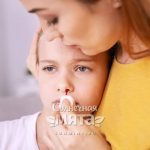 Mom wipes blood from her daughter&#39;s nose, photo