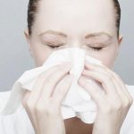 woman sneezes